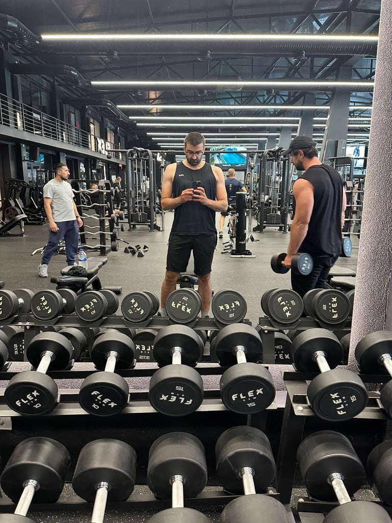A Be The One builder training among weights, connecting physical discipline with product philosophy