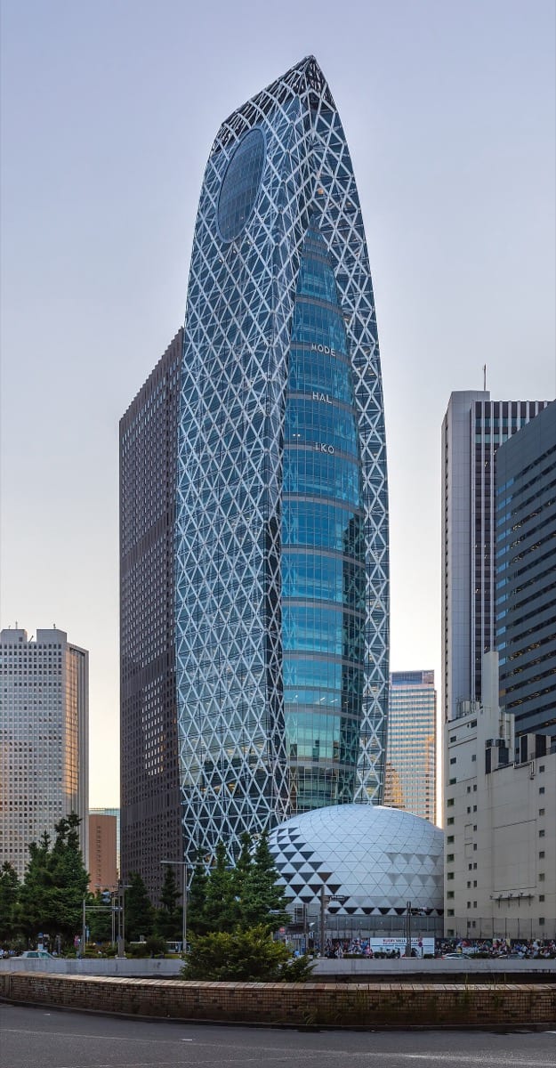 Finished skyscraper rising against an evening sky, the visible result of long quiet work: results speak louder than any announcement could