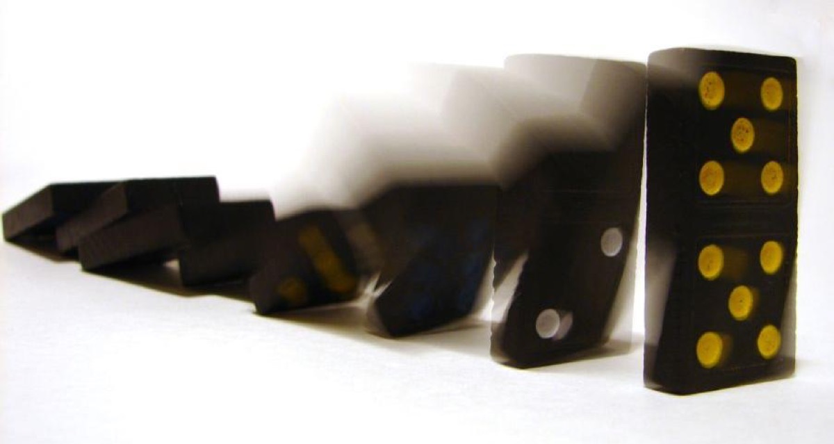 Dominoes falling in sequence: one choice tips over the next, which is how the croissant principle actually works in daily life