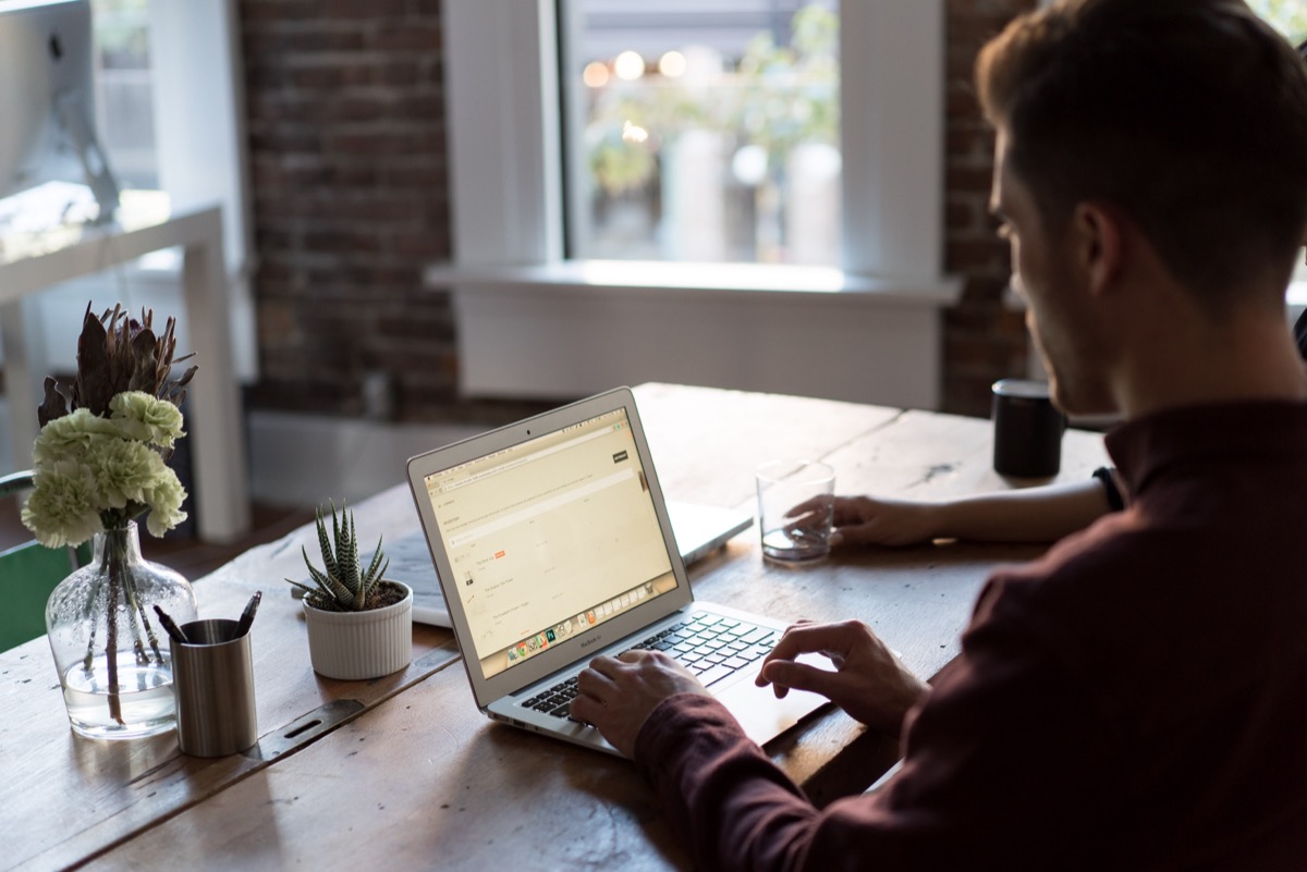Person working at a laptop in an office: your value is measured by your current contribution, not your historical one
