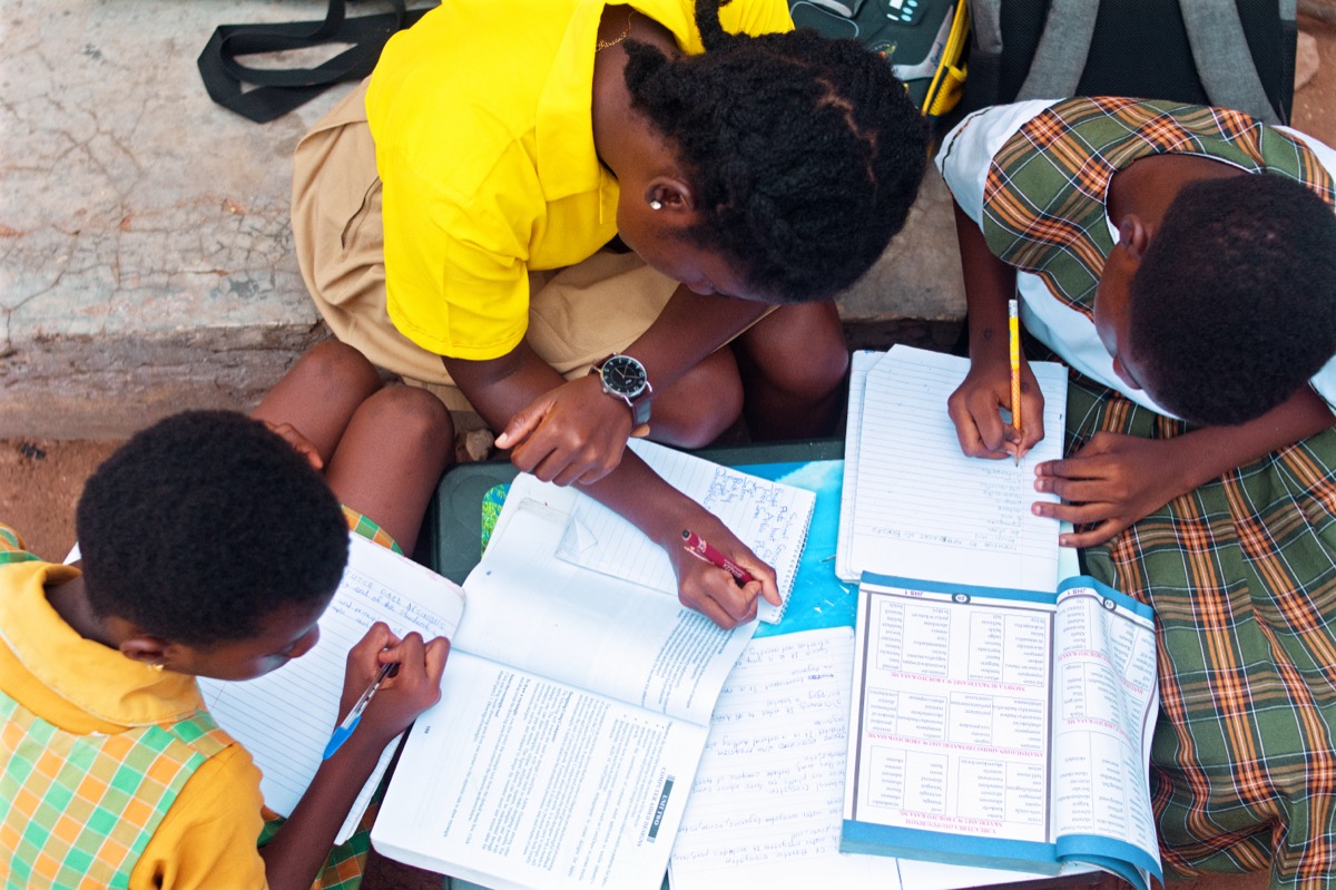Person studying and writing at a desk, focused on their work