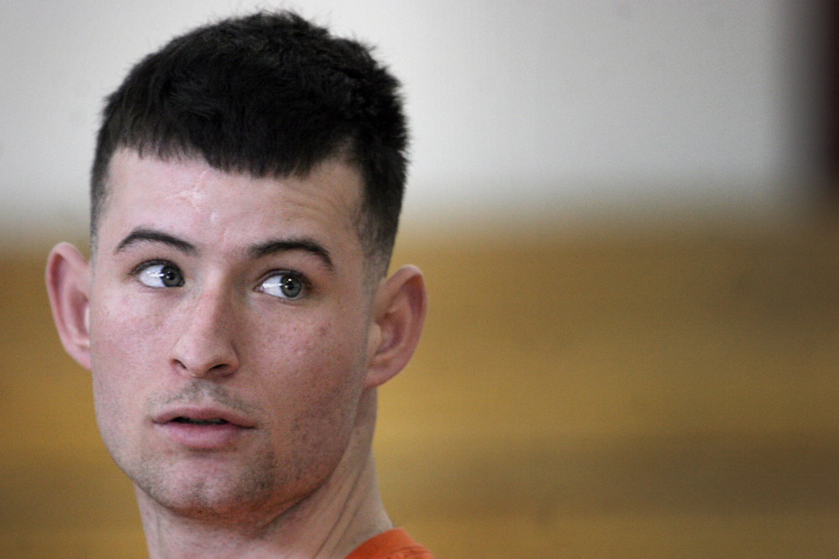 A Marine coach demonstrating technique to an attentive athlete during training