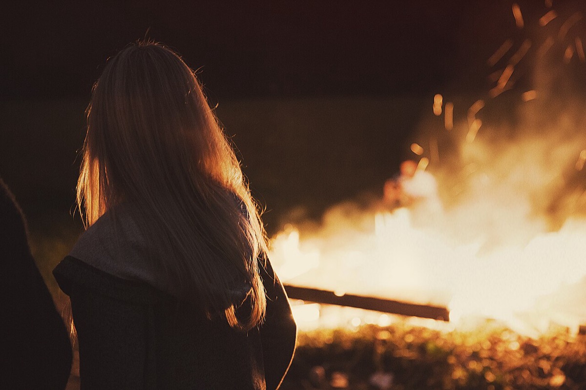 Flames burning in the dark, a metaphor for desire tested by hardship
