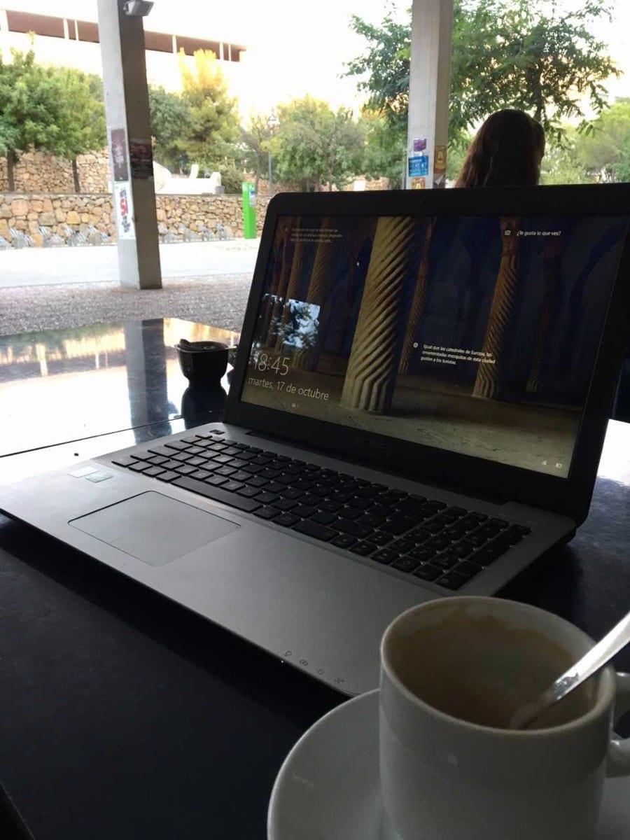 Someone working on a laptop in the quiet early morning: the kind of undistracted effort early rising allows