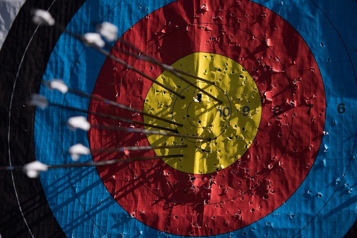 Arrows clustered in the center of an archery target: focused effort concentrated on one thing beats scattered effort across many