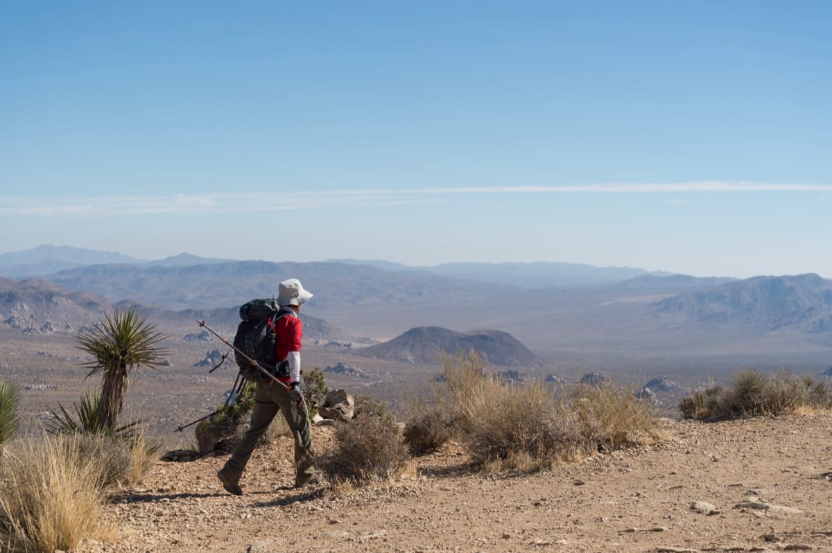 Hiker standing at a mountain summit: personal responsibility turns circumstances into terrain, not verdicts